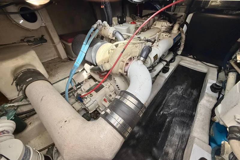 Slide: The Image of Engine room of a 1998 Riviera 34 Convertible boat, showcasing mechanical components. - 34