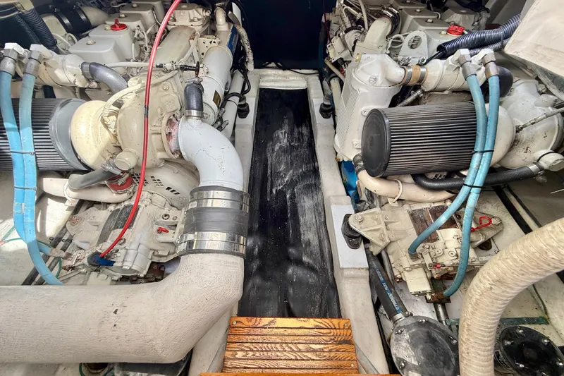 Slide: The Image of Engine room of a 1998 Riviera 34 Convertible boat, showcasing dual engines and components. - 35