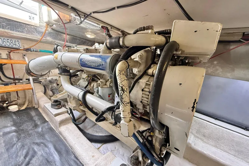 Slide: The Image of Engine room of a 1998 Riviera 34 Convertible boat, showcasing a diesel engine. - 37