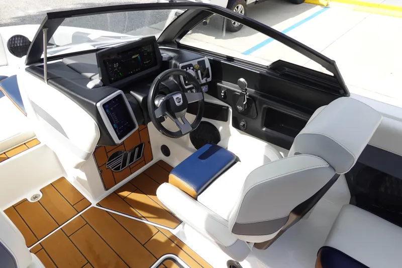 Slide: The Image of 2022 Malibu Wakesetter 23 MXZ boat interior with modern dashboard and seating. - 10