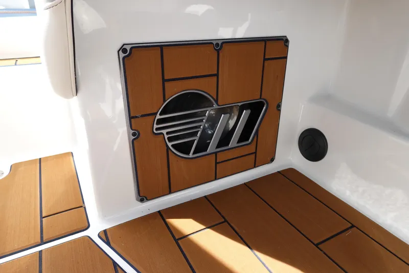 Slide: The Image of 2022 Malibu Wakesetter 23 MXZ interior with teak-style flooring and logo detail. - 14