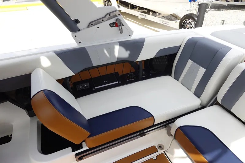 Slide: The Image of 2022 Malibu Wakesetter 23 MXZ interior seating with blue, white, and tan upholstery. - 18