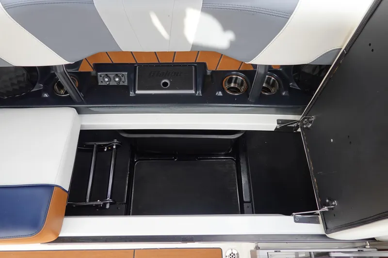 Slide: The Image of 2022 Malibu Wakesetter 23 MXZ interior storage compartment with cup holders and seating. - 19