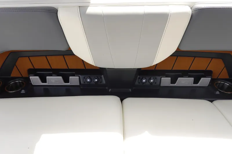 Slide: The Image of 2022 Malibu Wakesetter 23 MXZ interior seating with cup holders and control panel. - 24