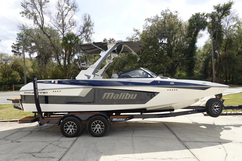 Slide: The Image of 2022 Malibu Wakesetter 23 MXZ boat on trailer, parked outdoors. - 3