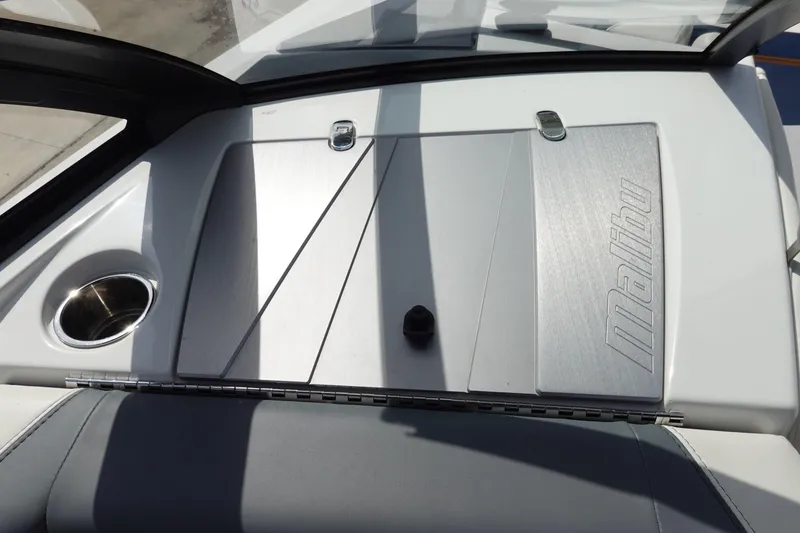 Slide: The Image of 2022 Malibu Wakesetter 23 MXZ boat dashboard with cup holder and sleek design. - 31