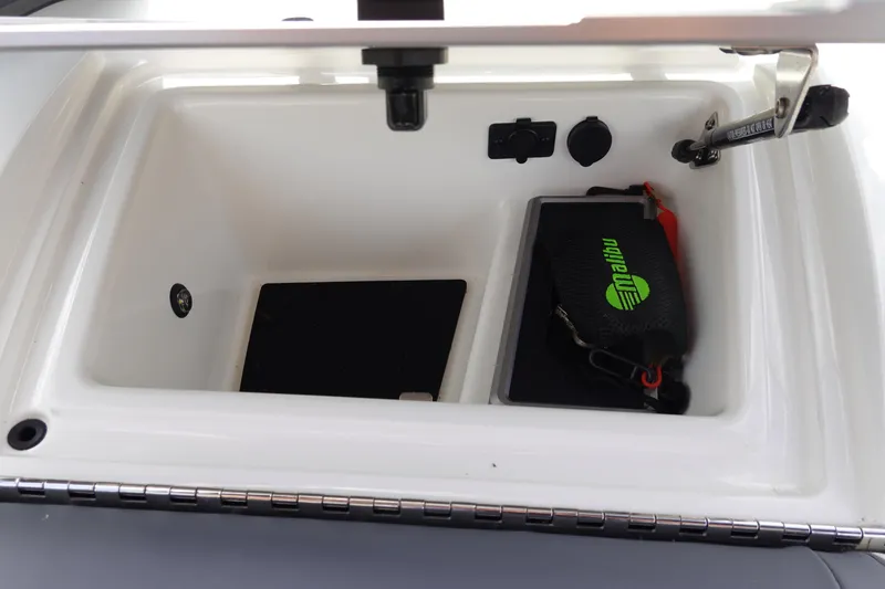 Slide: The Image of 2022 Malibu Wakesetter 23 MXZ storage compartment with accessories and controls. - 32