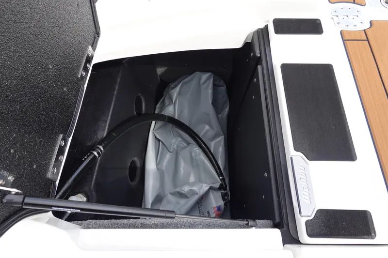 Slide: The Image of 2022 Malibu Wakesetter 23 MXZ storage compartment with ballast bag and hose. - 41
