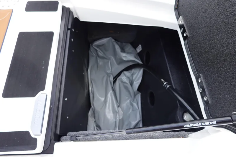 Slide: The Image of Open storage compartment in 2022 Malibu Wakesetter 23 MXZ boat. - 42