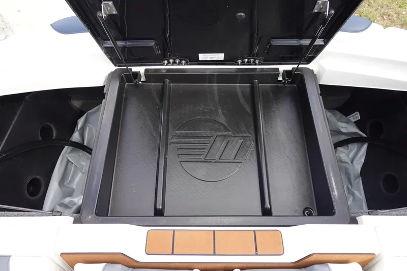 Slide: The Image of 2022 Malibu Wakesetter 23 MXZ storage compartment with open lid, showcasing interior design. - 43