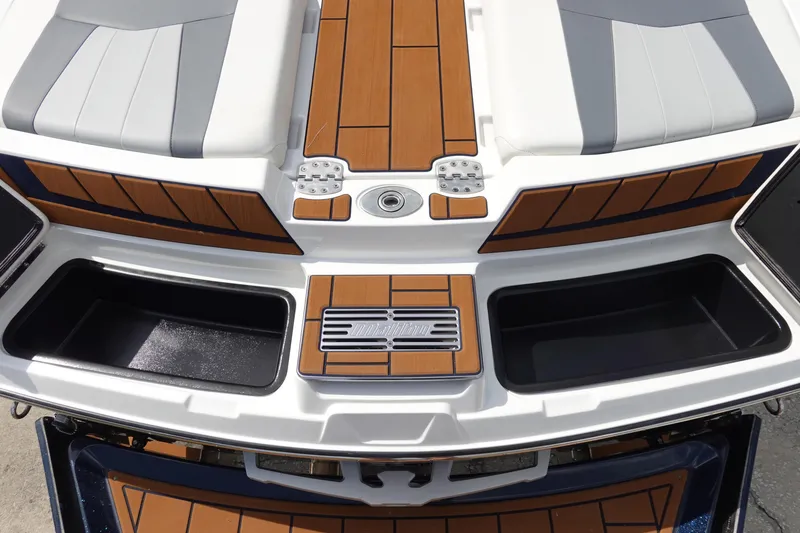 Slide: The Image of 2022 Malibu Wakesetter 23 MXZ boat deck with storage compartments and seating. - 8