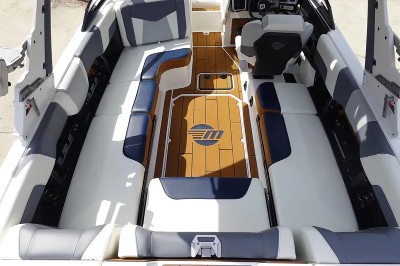 Slide: The Image of 2022 Malibu Wakesetter 23 MXZ interior with stylish seating and wood accents. - 9