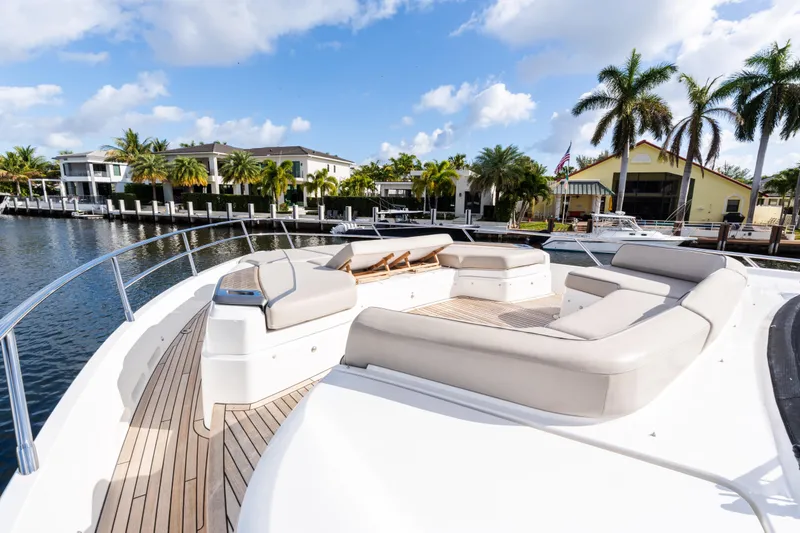 Slide: The Image of Luxurious 2019 Princess S78 yacht with spacious deck, docked near waterfront homes and palm trees. - 30