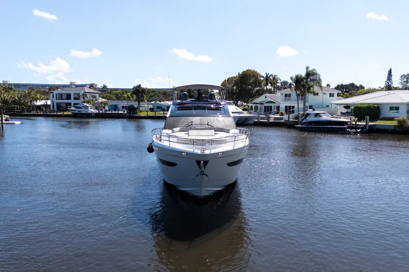 Slide: The Image of Luxury 2019 Princess S78 yacht on a serene waterfront, surrounded by modern homes. - 34
