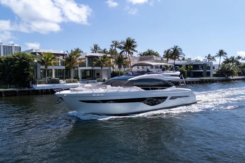 Slide: The Image of Luxurious 2019 Princess S78 yacht cruising near waterfront homes under a clear blue sky. - 39