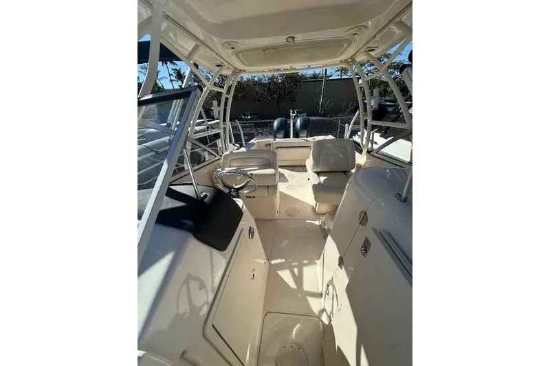 Slide: The Image of 2018 Grady-White Freedom 255 boat interior with seating and steering wheel. - 11
