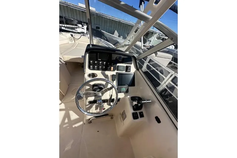 Slide: The Image of 2018 Grady-White Freedom 255 boat cockpit with steering wheel and control panel. - 12