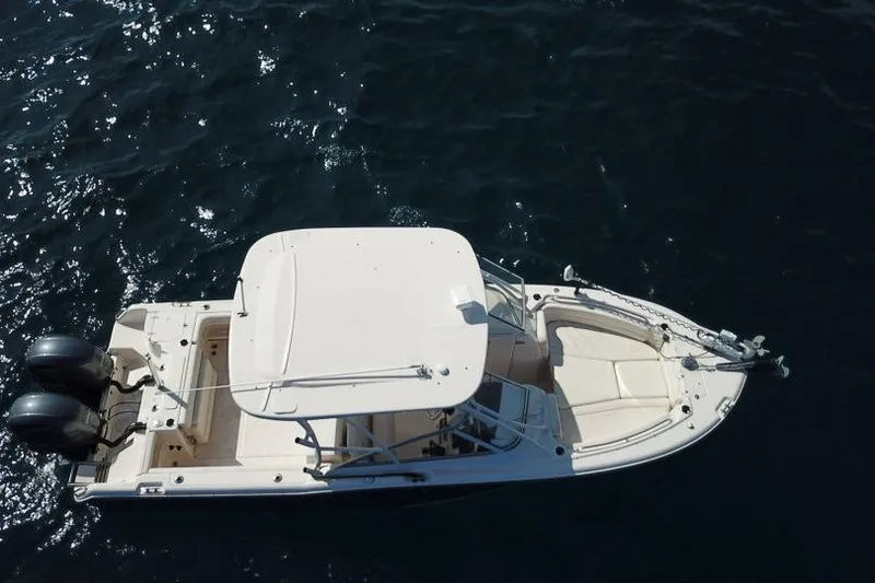 Slide: The Image of 2018 Grady-White Freedom 255 boat on dark water, aerial view. - 2