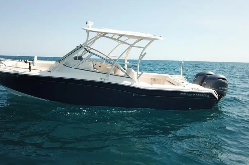Slide: The Image of 2018 Grady-White Freedom 255 boat on open sea, featuring dual Yamaha engines. - 3