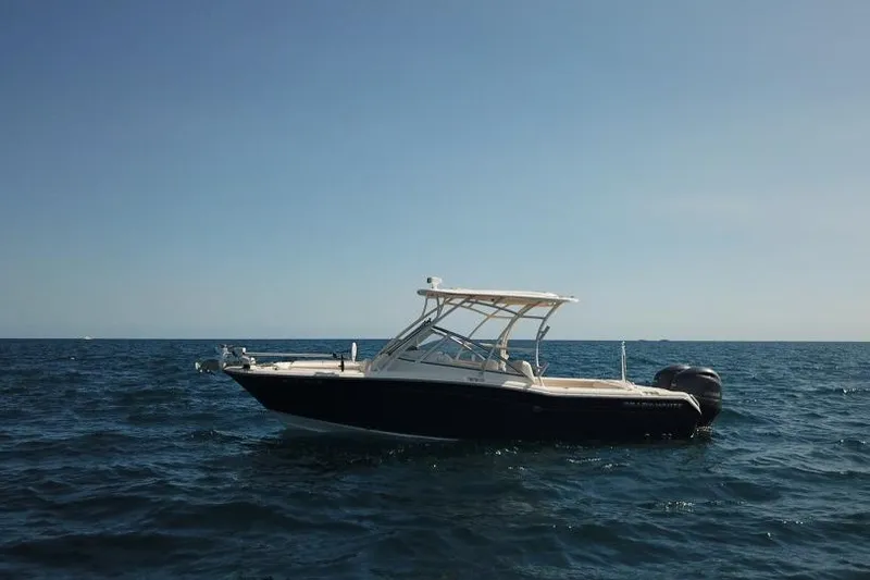 Slide: The Image of 2018 Grady-White Freedom 255 boat on open sea under clear sky. - 5