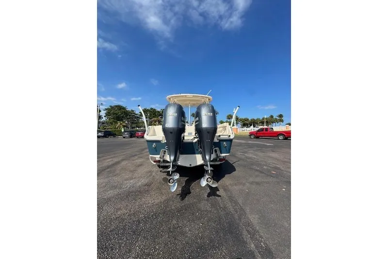 Slide: The Image of 2018 Grady-White Freedom 255 boat with dual outboard engines in a parking lot. - 7
