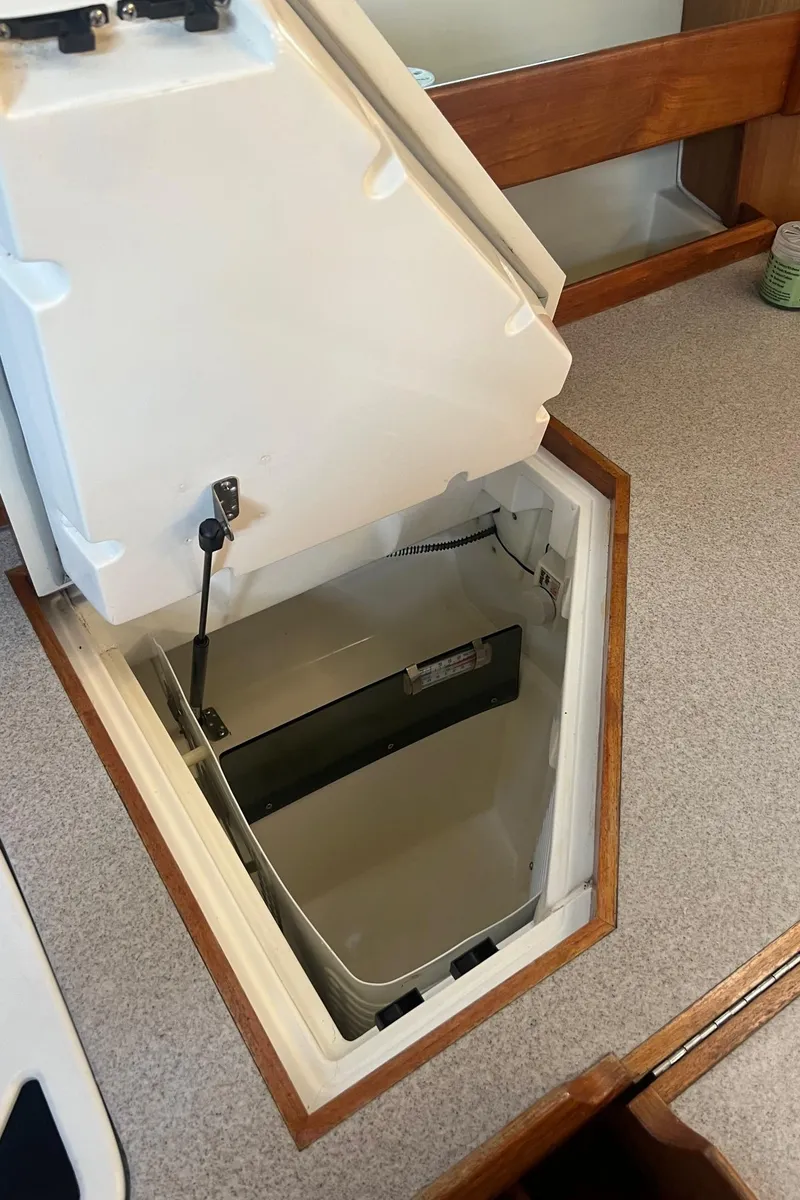 Slide: The Image of Open storage compartment on 1992 Hunter 43 boat with white interior. - 11
