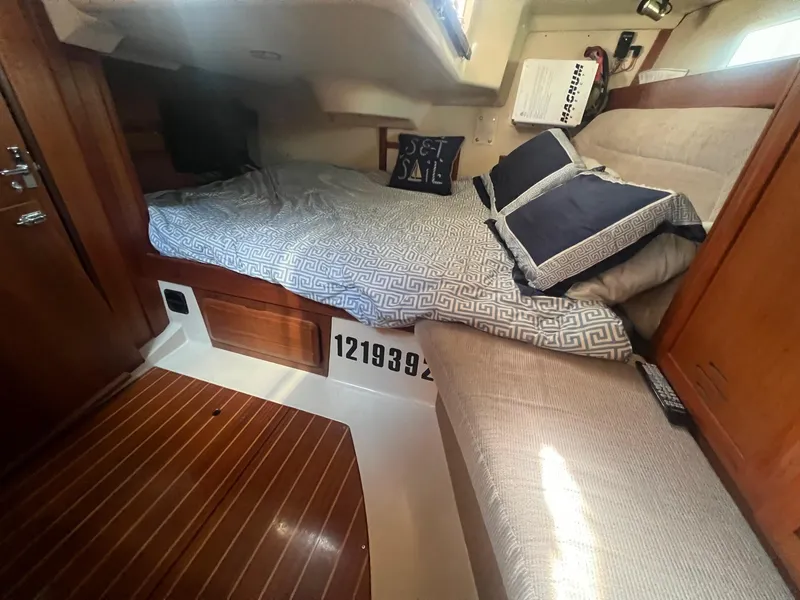 Slide: The Image of Cozy cabin interior of 1992 Hunter 43 sailboat with bed and wooden flooring. - 12