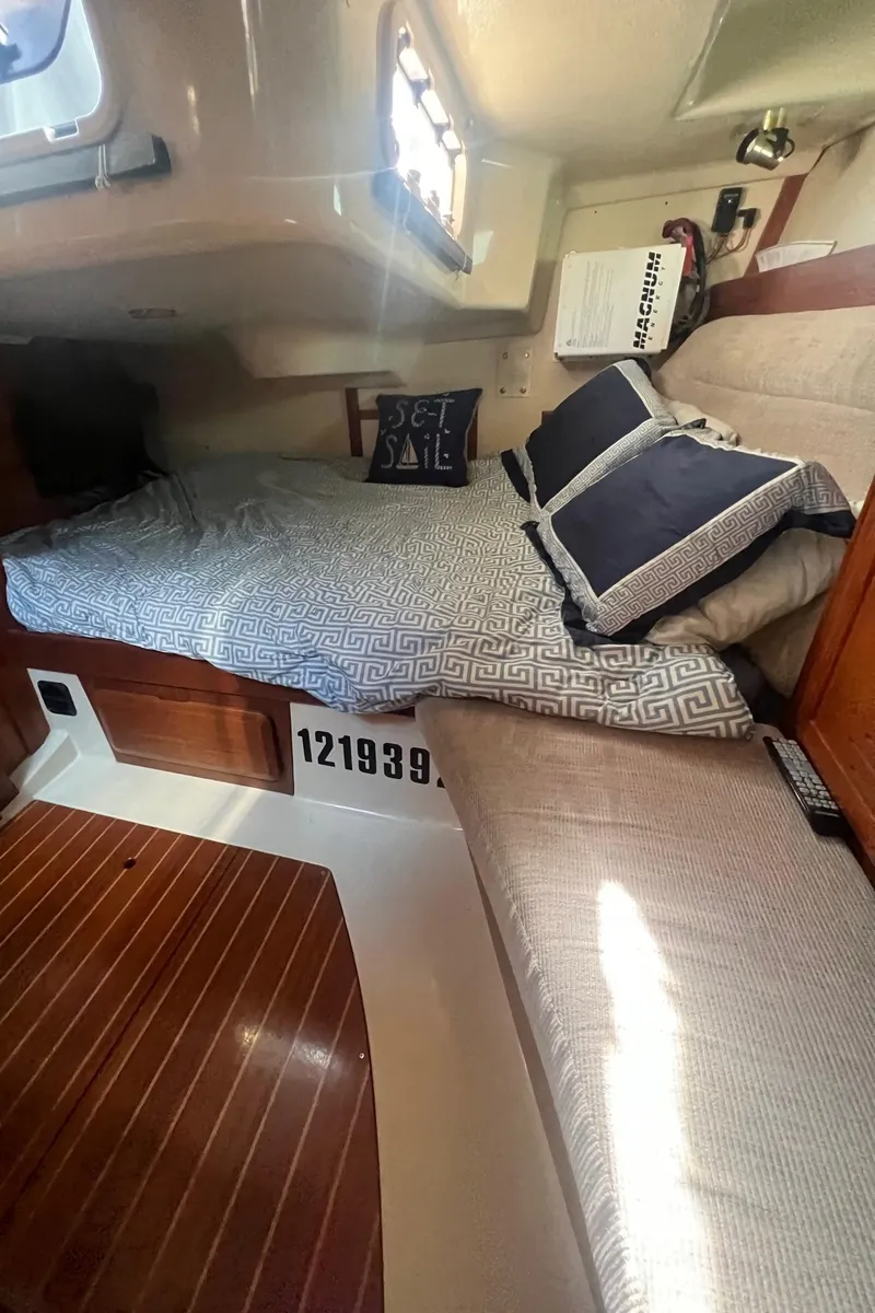 Slide: The Image of Cozy cabin interior of 1992 Hunter 43 sailboat with comfortable bedding and wooden flooring. - 13