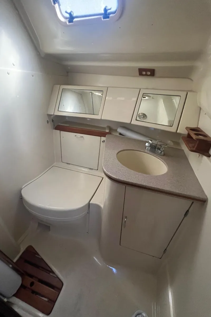 Slide: The Image of 1992 Hunter 43 yacht bathroom with sink, toilet, and storage cabinets. - 15