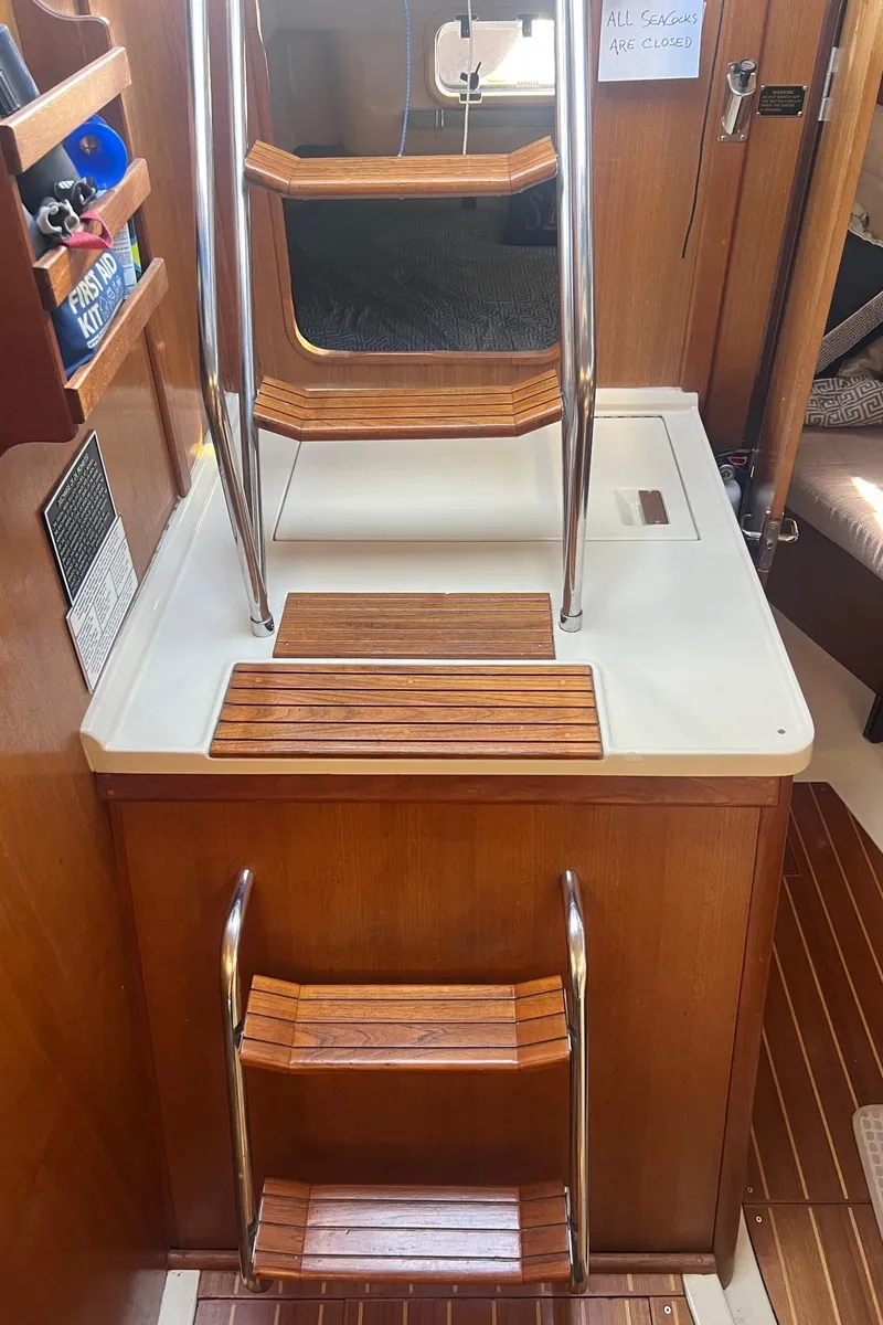 Slide: The Image of Interior of 1992 Hunter 43 sailboat with wooden steps and stainless steel handrails. - 16
