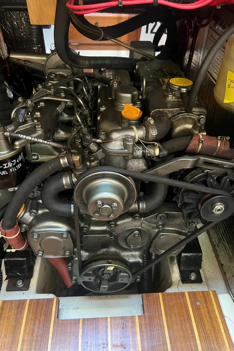 Slide: The Image of Engine of a 1992 Hunter 43 sailboat, showcasing mechanical components and belts. - 17