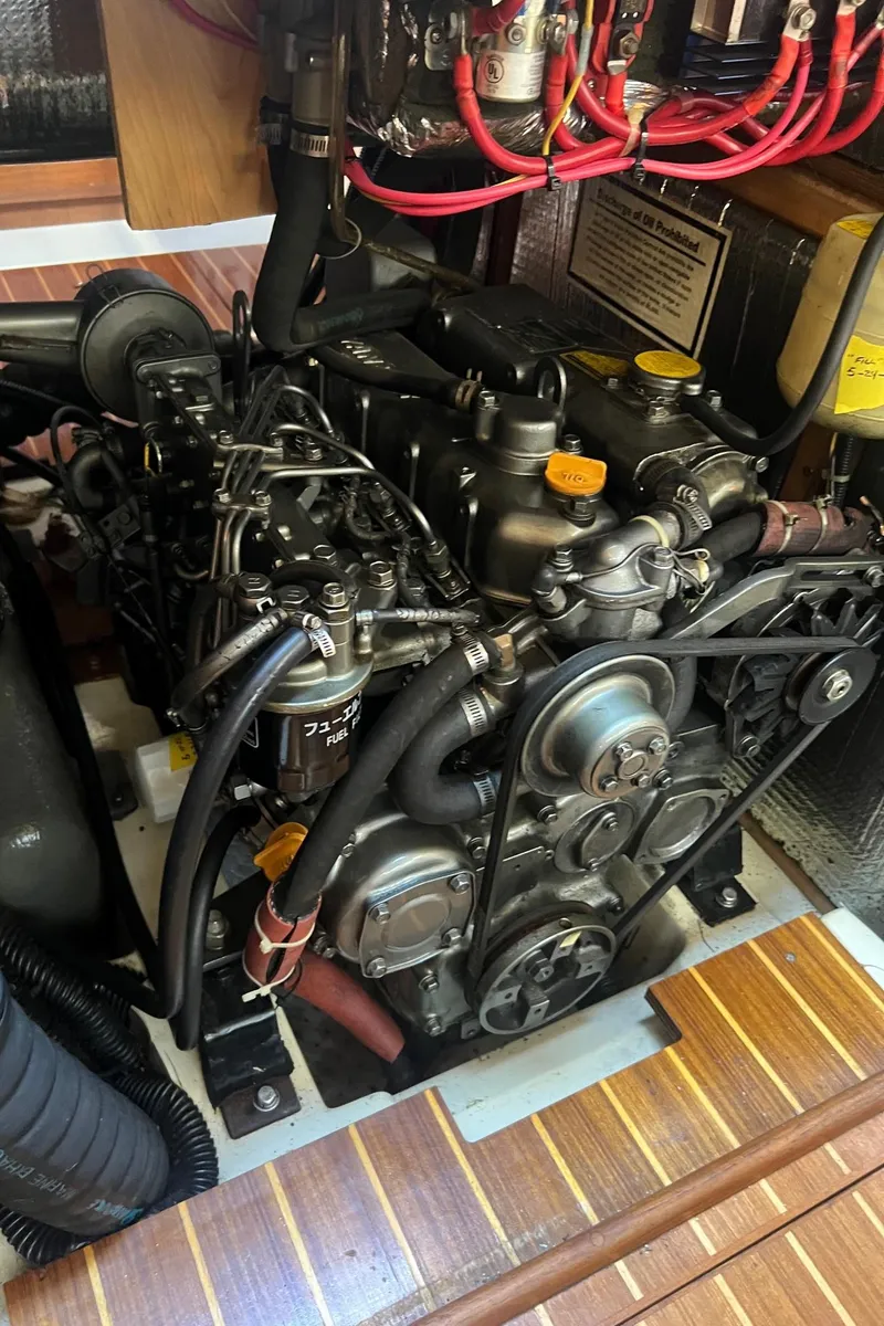Slide: The Image of Engine compartment of a 1992 Hunter 43 sailboat, showcasing detailed mechanical components. - 18
