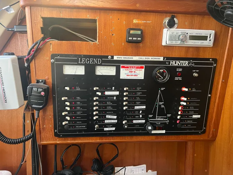 Slide: The Image of Electrical control panel on a 1992 Hunter 43 sailboat, featuring various switches and gauges. - 19