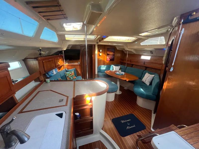 Slide: The Image of Interior of a 1992 Hunter 43 sailboat with cozy seating and wooden finishes. - 2