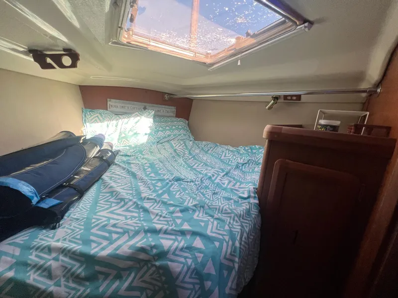 Slide: The Image of Cozy cabin interior of 1992 Hunter 43 sailboat with patterned bedding and skylight. - 21