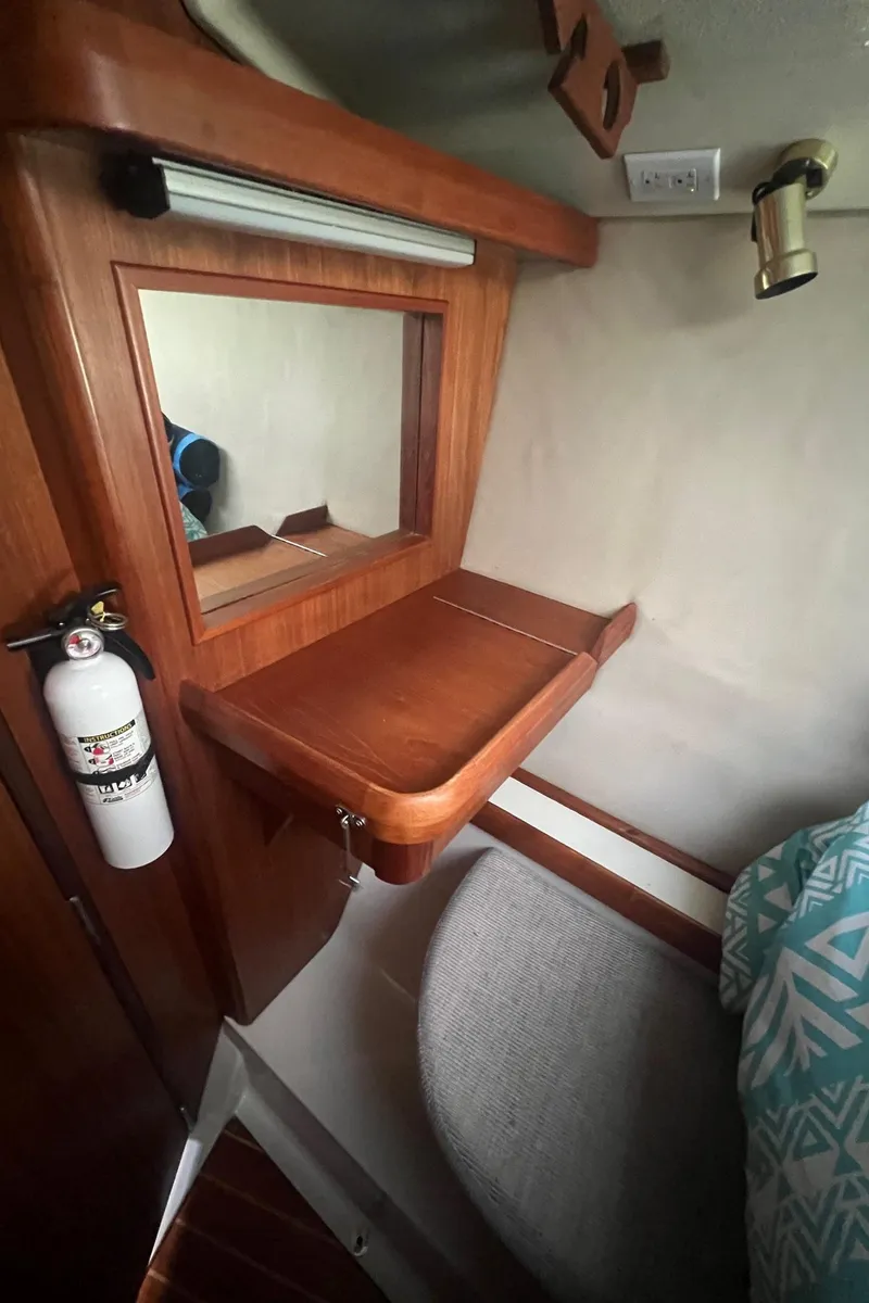 Slide: The Image of Cozy cabin interior of 1992 Hunter 43 sailboat with wooden desk and mirror. - 23