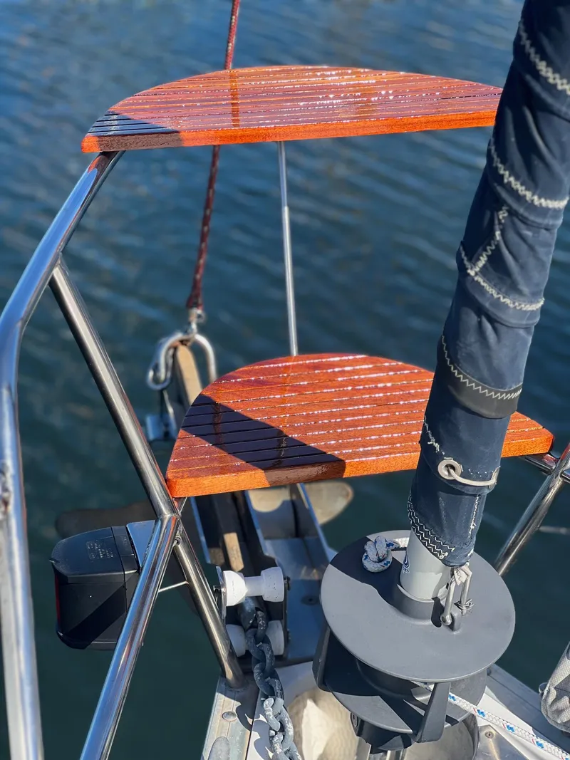 Slide: The Image of Bow of 1992 Hunter 43 sailboat with wooden steps and metal railing over water. - 28