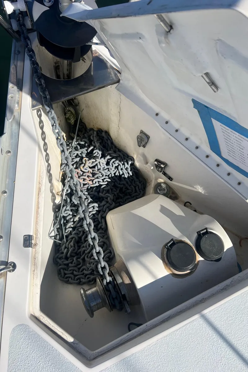 Slide: The Image of Anchor chain locker on a 1992 Hunter 43 sailboat, featuring winch and chain storage. - 30