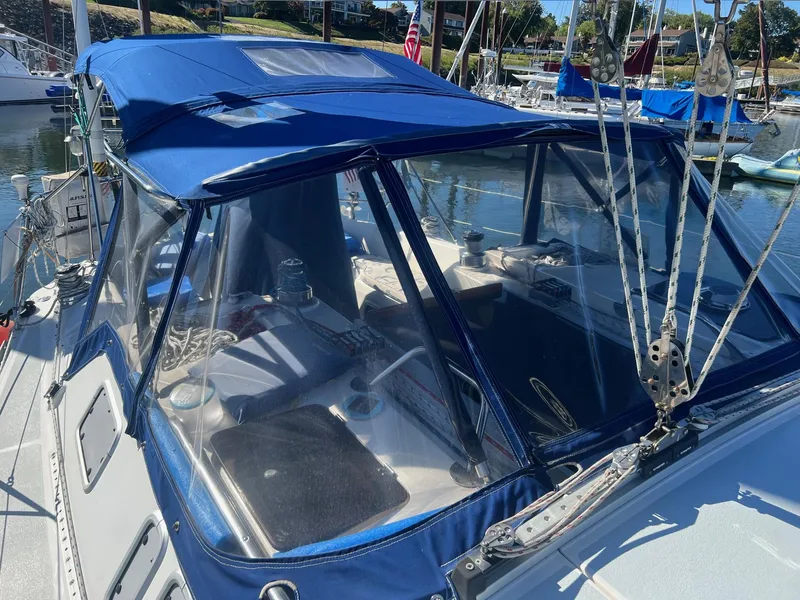 Slide: The Image of Sailboat cockpit with blue canopy, Hunter 43 model, 1992, docked in marina. - 35