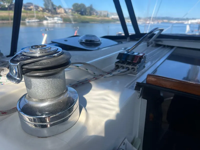 Slide: The Image of Sailboat deck of 1992 Hunter 43 with winch and control panel, overlooking marina. - 37
