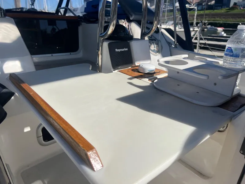 Slide: The Image of Cockpit of 1992 Hunter 43 sailboat with table and navigation equipment. - 38