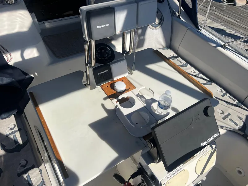 Slide: The Image of Cockpit of 1992 Hunter 43 sailboat with Raymarine navigation equipment and cup holders. - 39