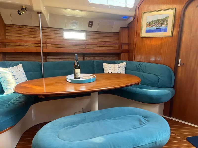 Slide: The Image of Cozy interior of 1992 Hunter 43 sailboat with blue seating and wooden table. - 4