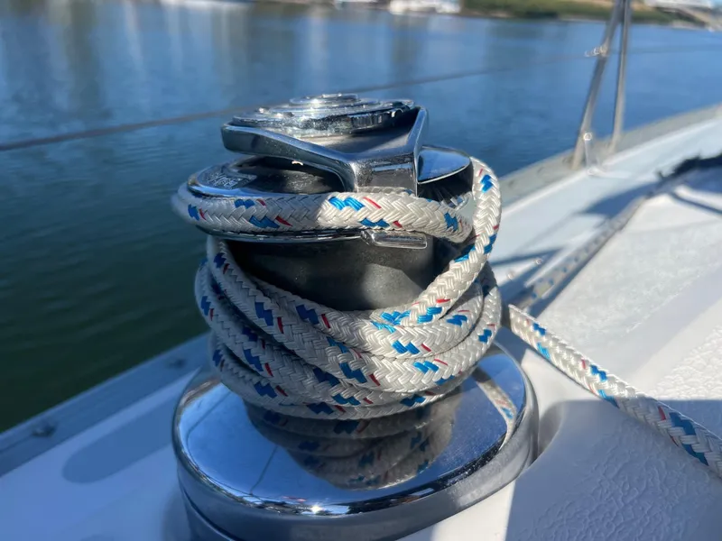 Slide: The Image of Winch with rope on 1992 Hunter 43 sailboat, docked by calm waters. - 40