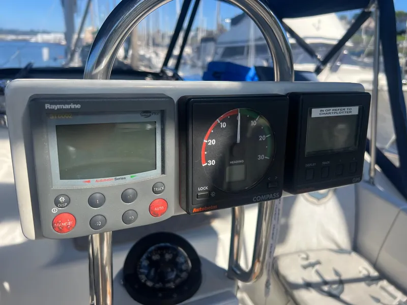 Slide: The Image of Cockpit instruments on a 1992 Hunter 43 sailboat, featuring navigation and compass displays. - 41
