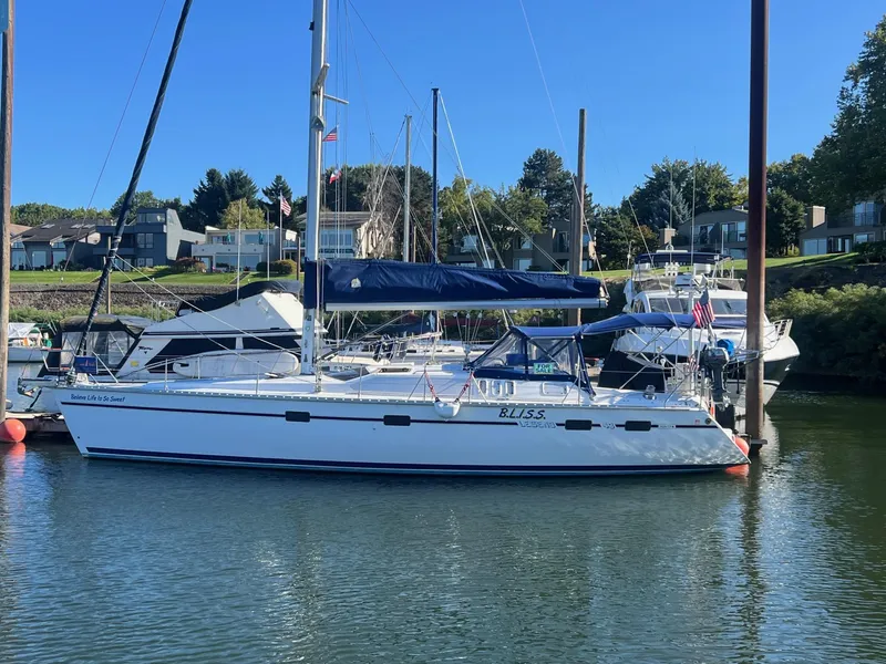Slide: The Image of Sailboat Hunter 43, 1992 model, docked in a marina on a sunny day. - 46