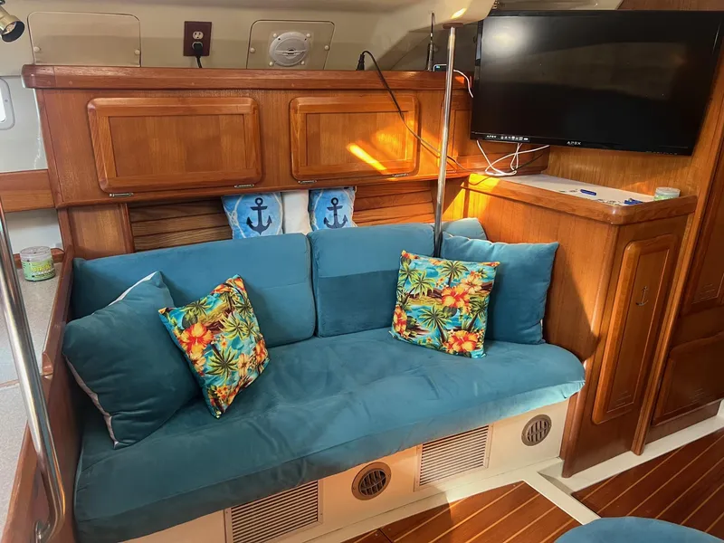 Slide: The Image of Cozy interior of 1992 Hunter 43 sailboat with blue cushions and tropical pillows. - 5