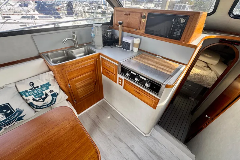 Slide: The Image of Cozy 1989 Mediterranean 38 yacht kitchen with wooden cabinetry and modern appliances. - 12