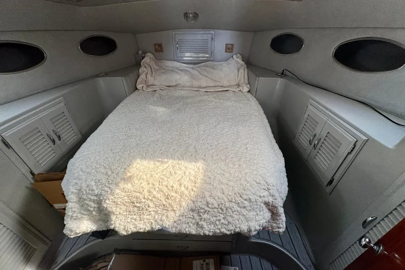 Slide: The Image of Cozy cabin interior of 1989 Mediterranean 38 boat with plush bedding and storage cabinets. - 13