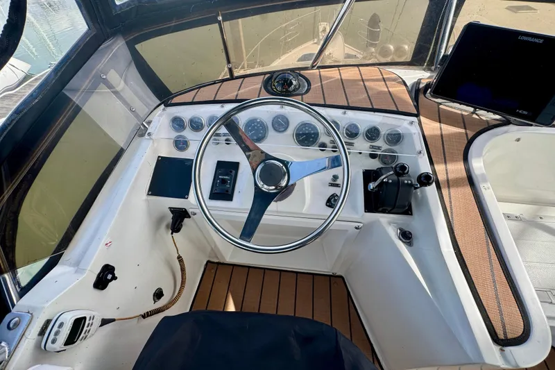 Slide: The Image of Cockpit of a 1989 Mediterranean 38 boat with steering wheel and control panel. - 18